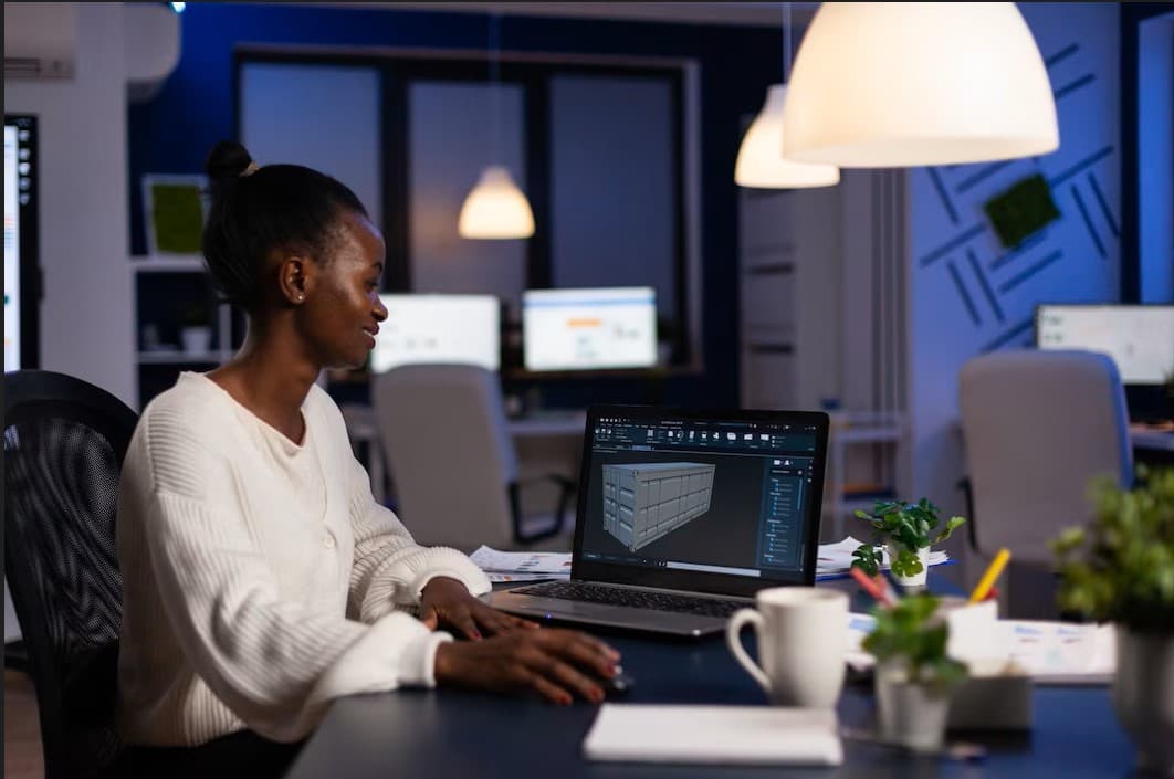 Creative technologist reviewing a digital model on a laptop workstation.